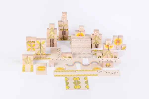 children stack blocks together in open-ended play