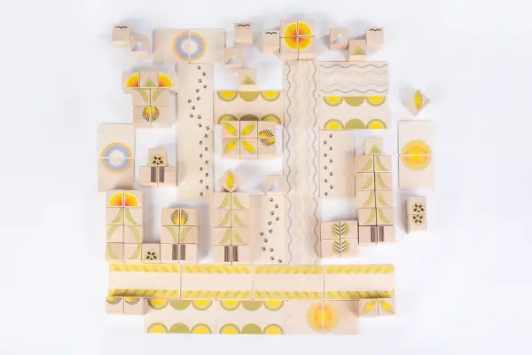 the girl builds a colorful city from blocks