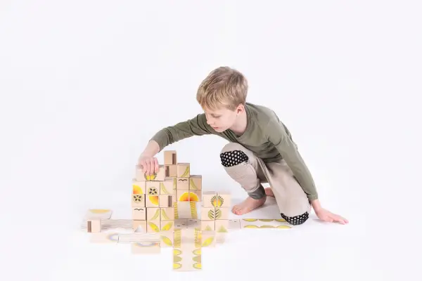 boy playing with colorful wooden blocks