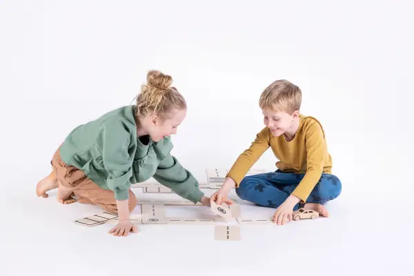 boy builds road for toy cars