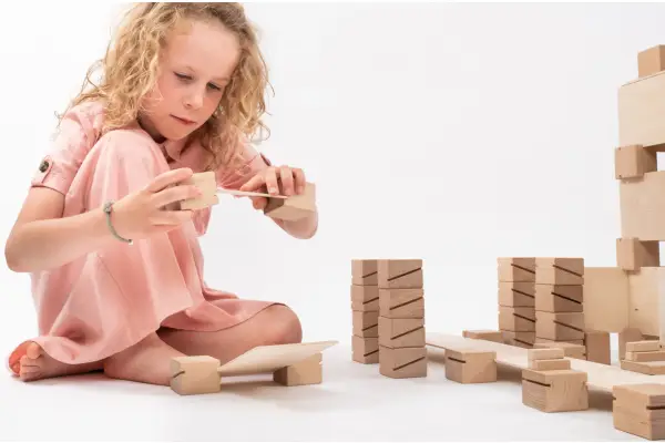 The girl is playing with sensory blocks.